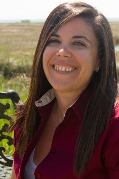 headshot of author Nicole Melleby, a brown-haired smiling woman in an outdoor setting